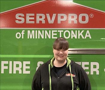 Female employee, fire crew leader in front of SERVPRO truck
